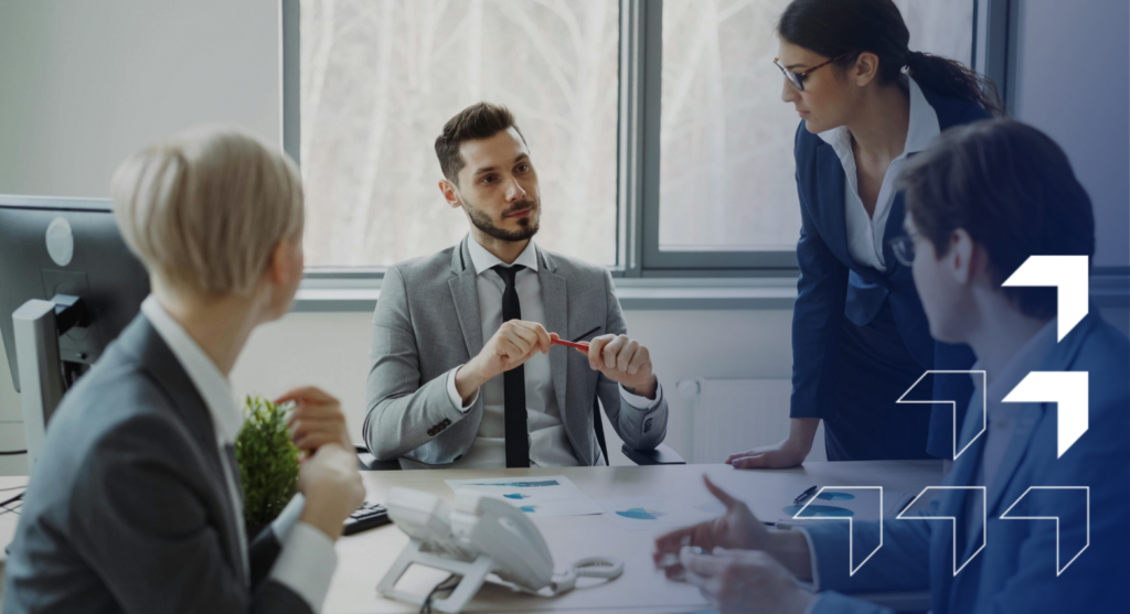 Business team meeting in modern office with man presenting data to colleagues around conference table